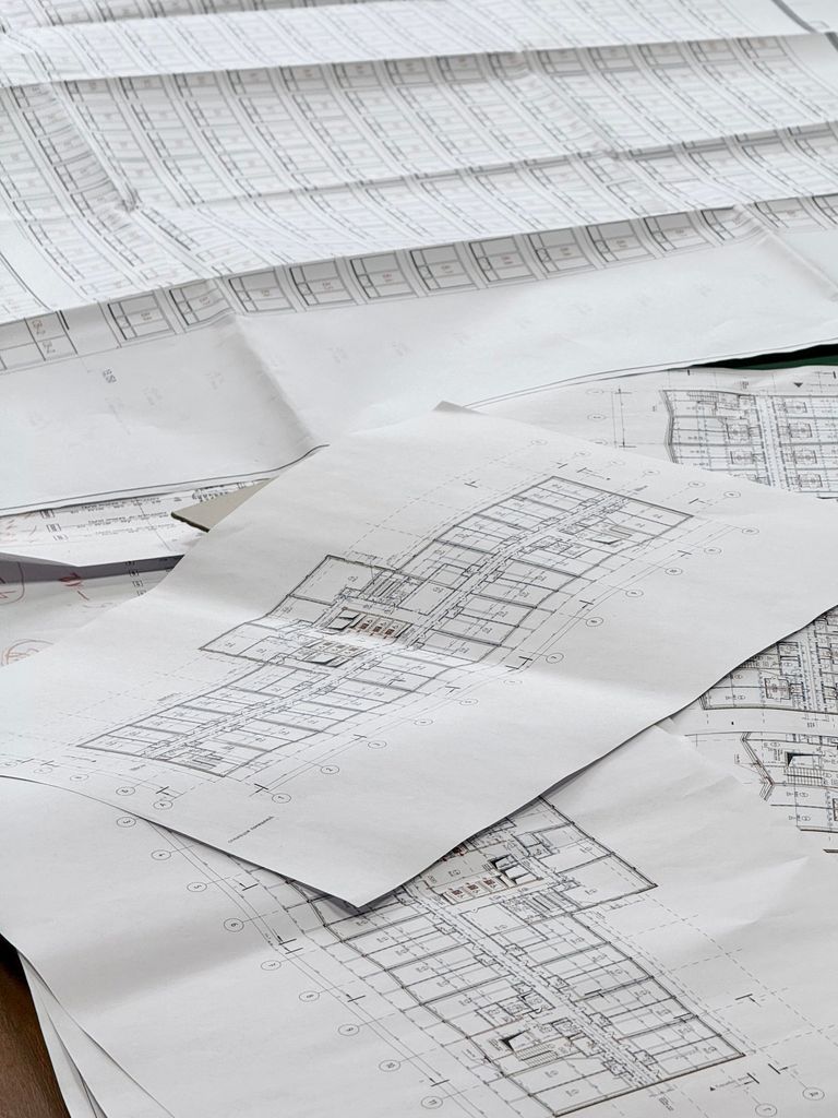 Bouwtekeningen en plattegronden op een bureau voor een AERIUS-berekening